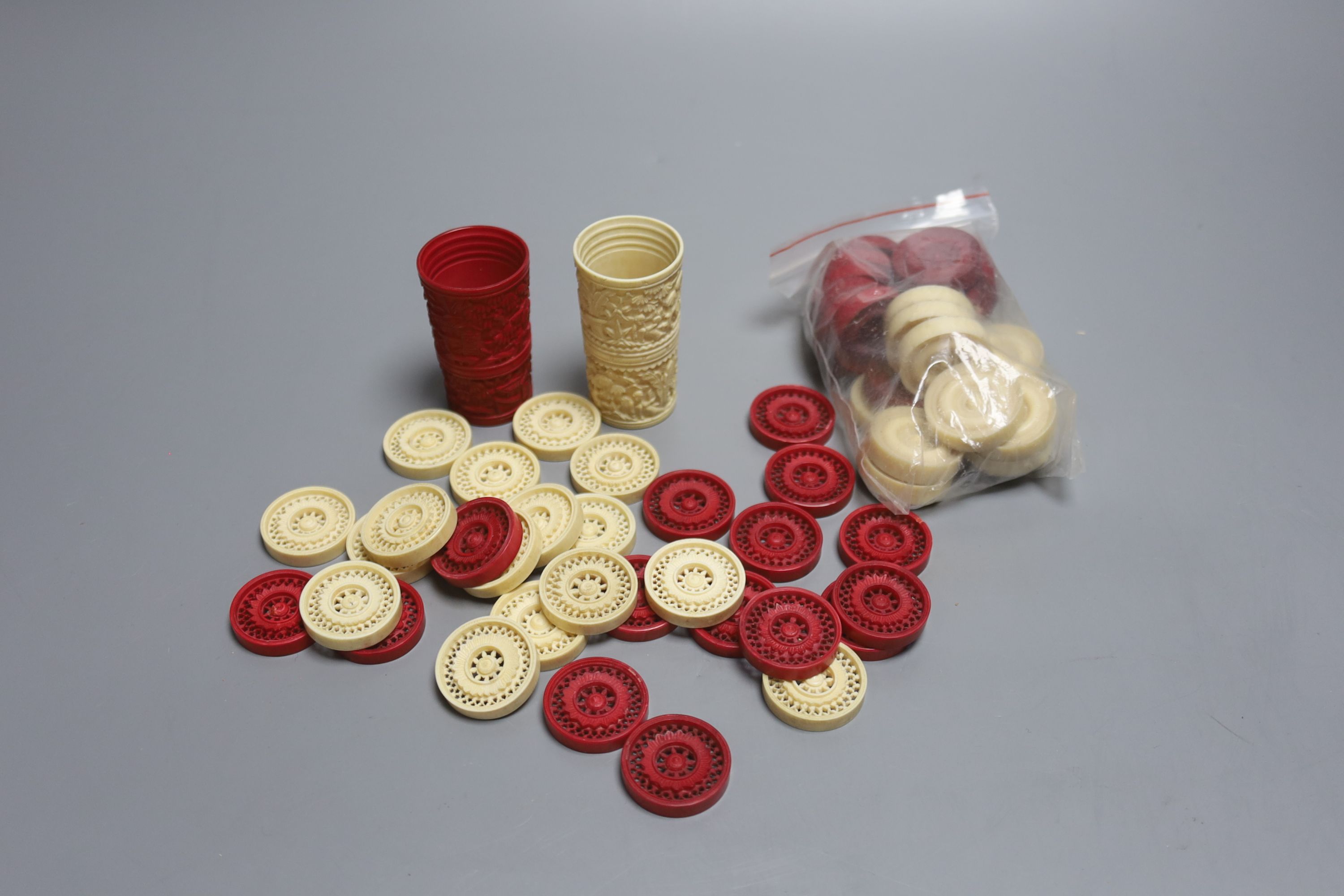 A 19th century Cantonese ivory draughts pieces and two dice shakers